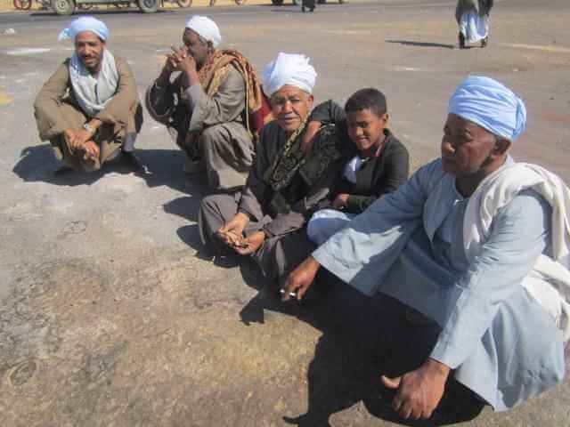 men_crouch_on_blocked_road