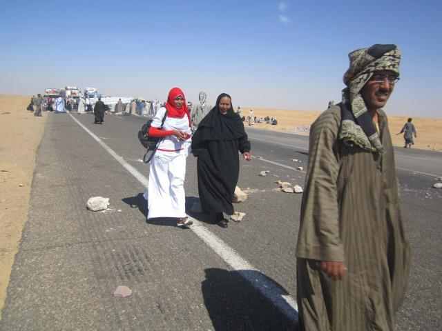 women_walk_down_blocked_road