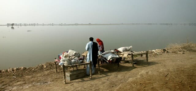 A family returning after being displaced by flooding in Pakistan. Creative Commons: Russell Watkins / DfID